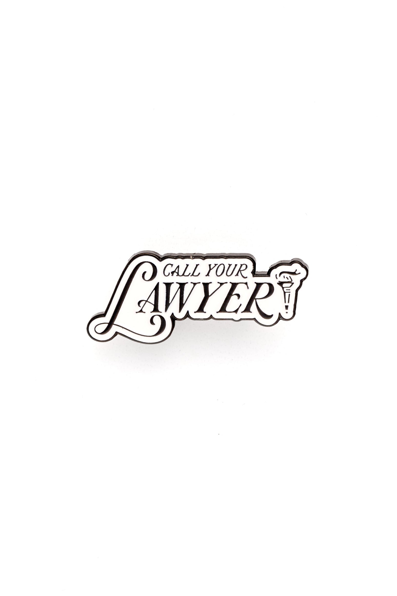White and black lapel pin with the text 'Call Your Lawyer' on a white background