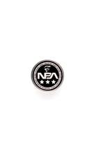 Black and white colored circular lapel pin with 'NBA' branding on a white background