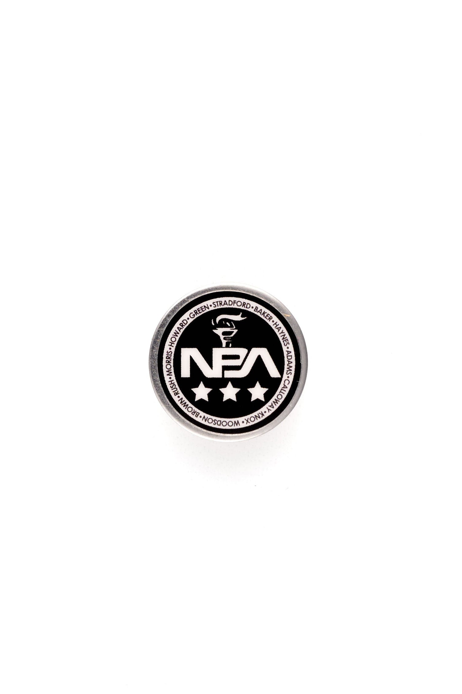 Black and white colored circular lapel pin with 'NBA' branding on a white background