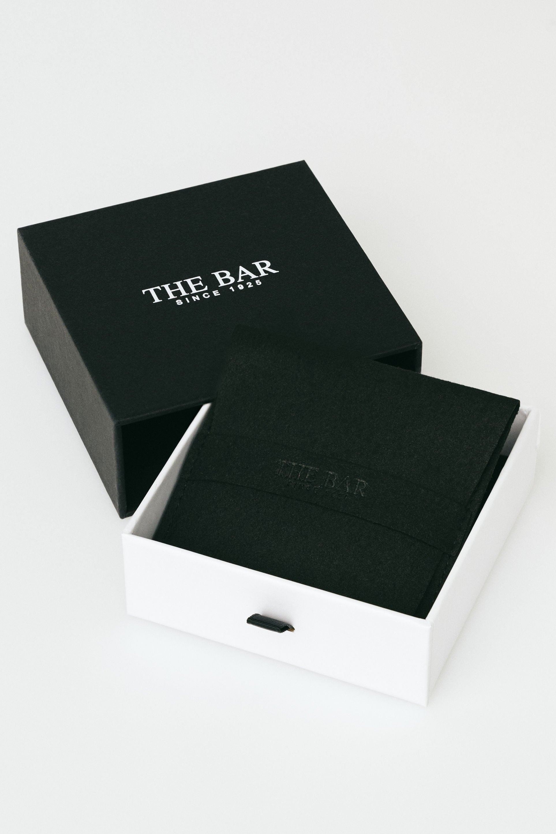 Black box with 'The Bar' branding on a white background